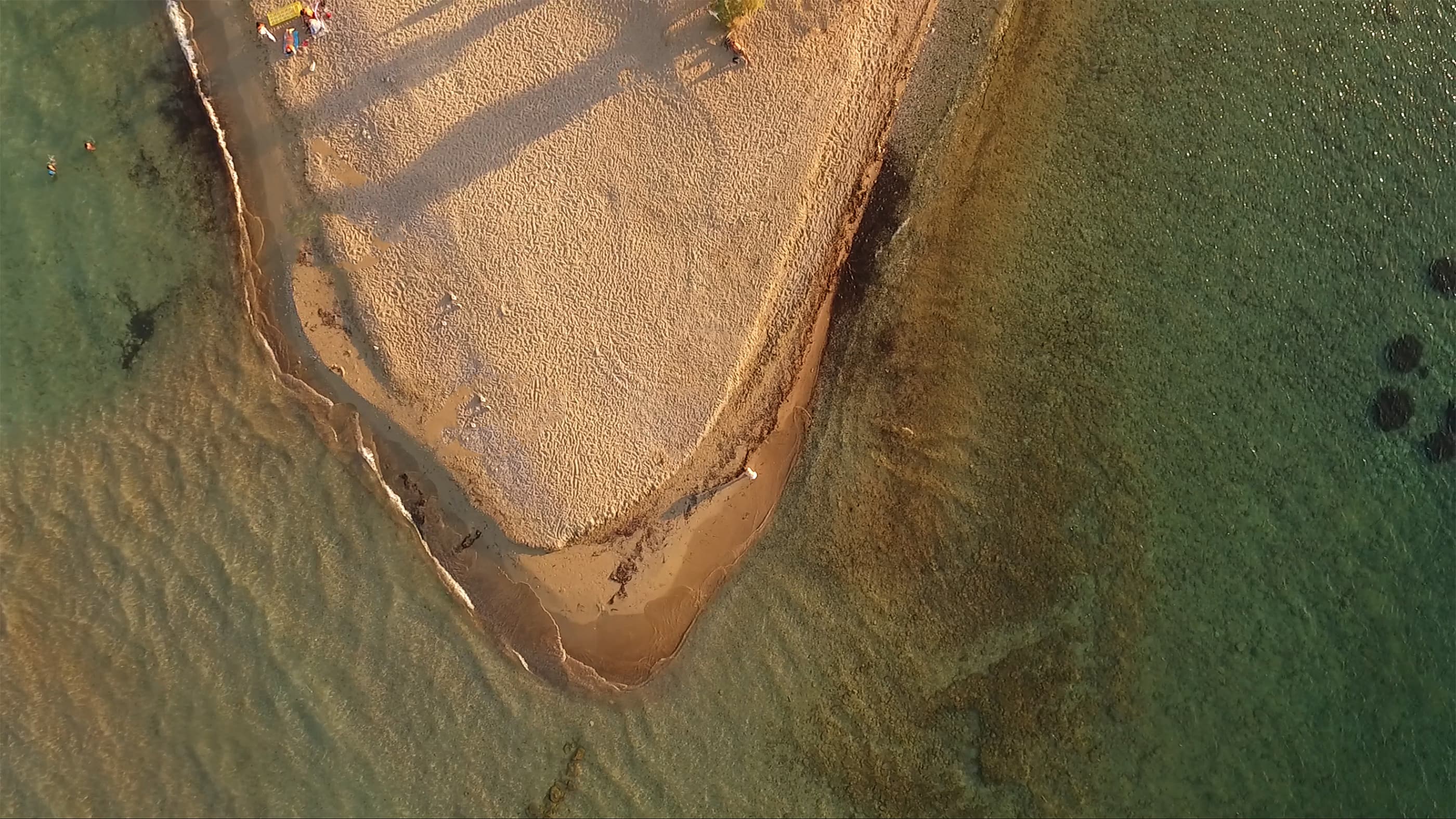 A view of the sea and small Greek houses surrounded by pine trees on Agistri island.